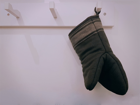 Black Kitchen Glove Hanging on the Hook at the Kitchen