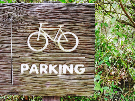 Bicycle Symbol and Parking Text on Wooden Textured Sign Boardの写真素材