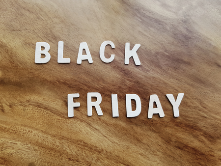 White Black Friday Texts on Wooden Table Backgroundの写真素材