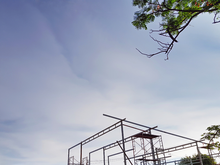 Low Angle View of Unfinished Warehouse Construction Against Blue Skyの写真素材