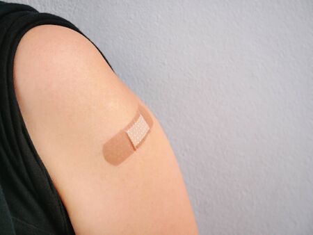 Close-up Medical Bandage on Arm After Vaccinationの写真素材