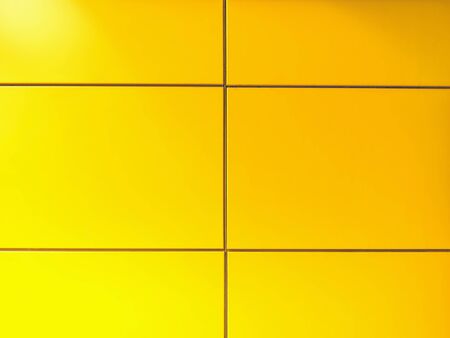 Full Frame Background of Vibrant Yellow Tiled Wallの写真素材