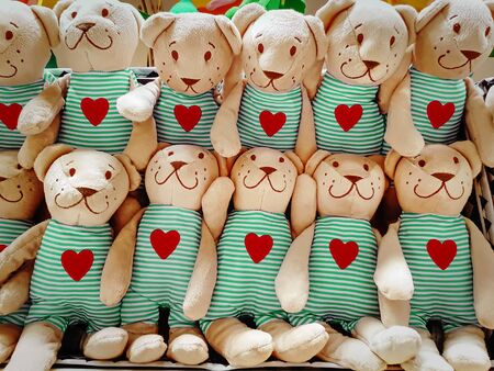 Group of Fluffy Stuffed Bear Toys Wearing Clothes with Red Heart Symbolsの写真素材