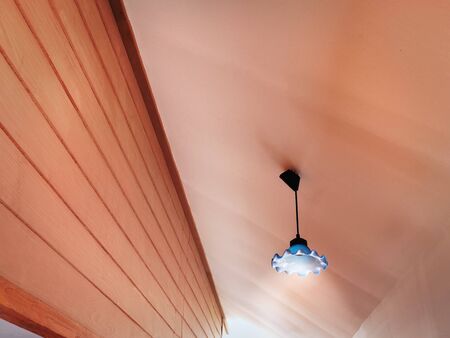 Low Angle View of Illuminated Lamp Hanging Under Ceiling