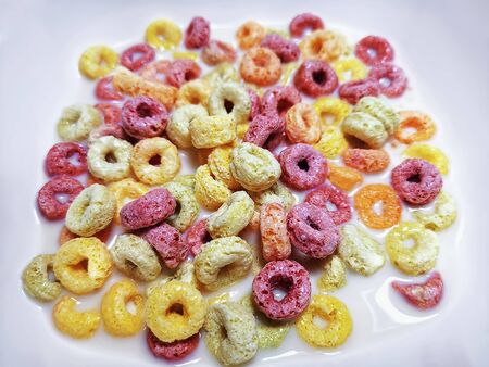 Colorful Ring-Shape Fruity Cereal with Milk in White Bowl