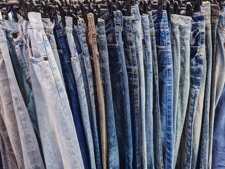 Full Frame Background of Hanging Denim Jeans for Sale