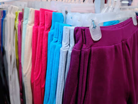 Soft Colorful Pants Hanging on the Rack For Sale at Clothing Store