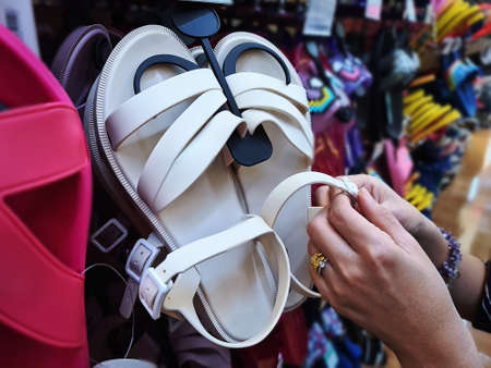 Close-up Woman Choosing Shoes at Retail Storeの写真素材
