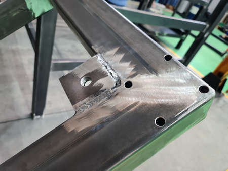 Close-up Welded Threaded Lug on Metal Frame at Workshop