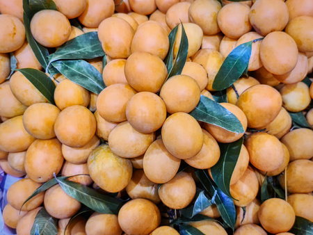 Full Frame Background of Pile of Orange Marian Plum Fruits