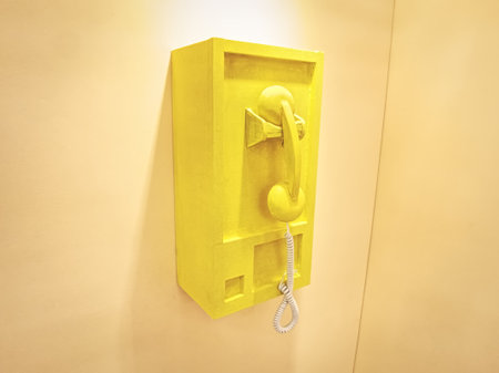 Retro-Style Wooden Telephone Concept Box Mounted on Yellow Wallの写真素材
