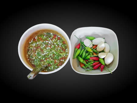 High Angle View of Hot and Spicy Seafood Sauce with Garlic and Chilies Isolated on Blackの写真素材