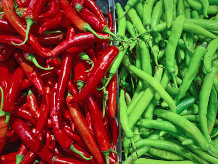 Full Frame Background of Two Halves of Red and Green Chilies for Saleの写真素材