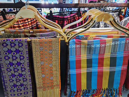 Traditional Thai-Style Patterned Clothes Hanging on Rackの写真素材