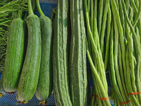 Piles of Fresh Green Vegetables for Sale at Market Stall