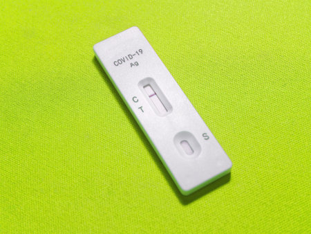 Negative Test Result of COVID-19 Rapid Antigen Test Kit on Light Green Backgroundの写真素材