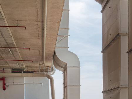 Low Angle View of Vertical White Air Ducts Mounted on the Buildingの写真素材
