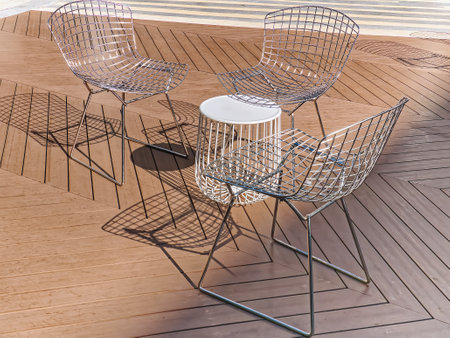 Outdoor Chairs Made of Stainless Steel Rods on Wooden Floorの写真素材