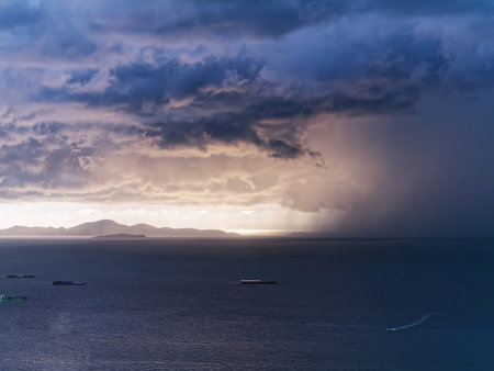 Scenic View of Sea and Mountain in Distance in Stormy Weather