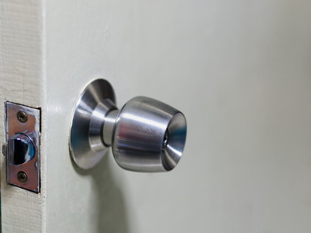 Close-up Metallic Door Knob on Wooden Doorの写真素材