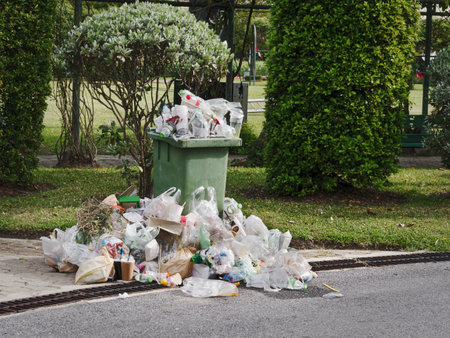 Waste Bin and Overflowing Garbage on Streetの写真素材