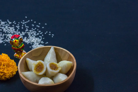delicious bengali rice flour coconut dumpling served during bengali indian festival of makar...