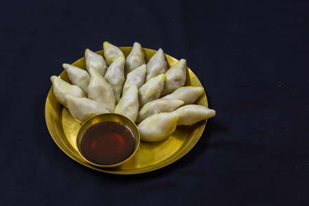 delicious bengali rice flour coconut dumpling served during bengali indian festival of makar...