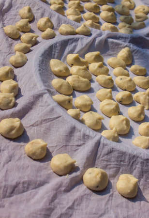 Bengali sun-dried dumplings or bori made of red lentil and black gram kept on white cloth for...