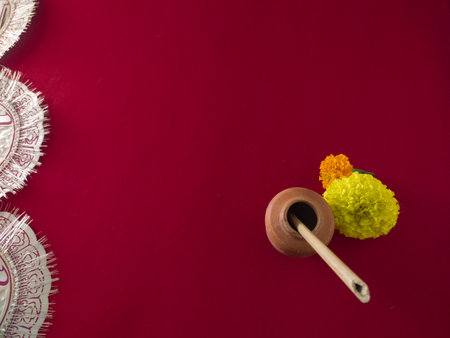 bengali hindu festival saraswati puja and vasant panchami. symbolic concept with copy space. ink pot made of clay, stick pen, marigold flower, symbolic to goddess saraswati, the goddess of education.の素材 [FY310181307682]