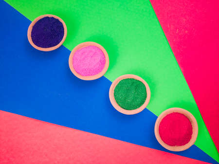 colorful powders for holi on clay pots on occasion of indian festival of colors. happy holi theme shot against multicolor background. copy space for text.の写真素材