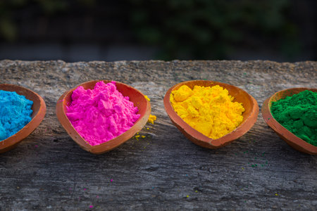 happy holi. gullal or abir, which are colorful powders for holi kept on clay pots or lamps on occasion of indian festival of colors. holi or dolyatra is festival of colors in india.の写真素材