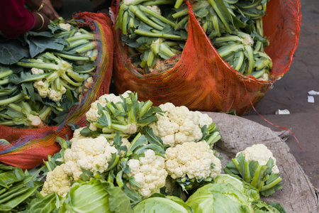 cauliflowers and cabbages being sold in vegetable market of kolkata. popular winter seasonal veggies for bengalisの写真素材