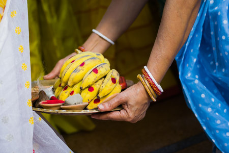 Varan ritual is being performed with boron dala by Indian woman in traditional attire. Boron dala is used for welcoming or blessing the bride during hindu marriage or puja.の写真素材