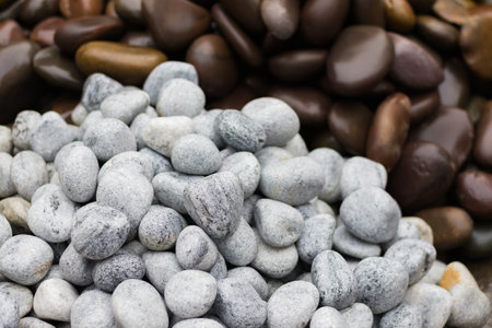 White and brown stones or pebbles of round shapes kept in piles.の写真素材