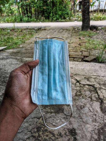 mask that is in the hand of the road background