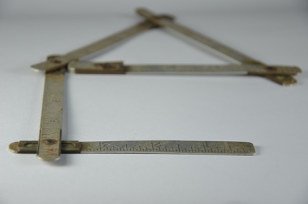 Old metal collapsible meter with figures and a scaleの写真素材