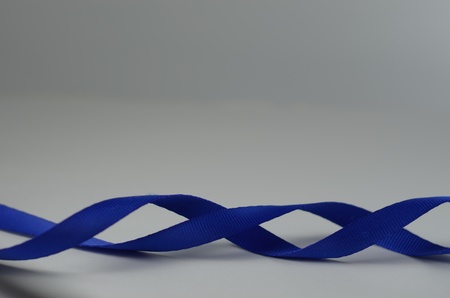 Blue ribbon on white background の写真素材