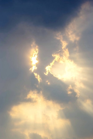 Light from the sun shining through the clouds の写真素材
