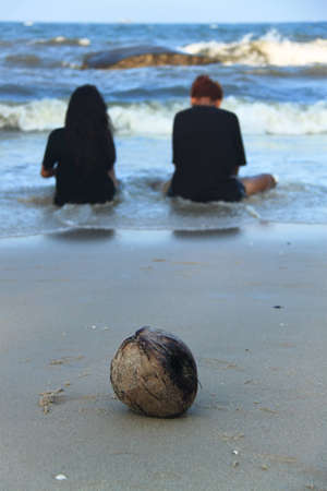 Coconut on the beach with teenagers