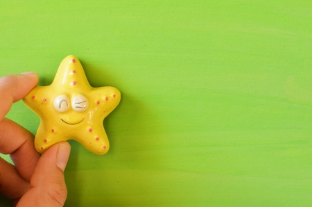 Yellow star on green paper color  texture background