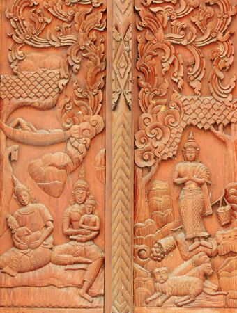 Thai ancient wood art on door temple in Thailand.の写真素材