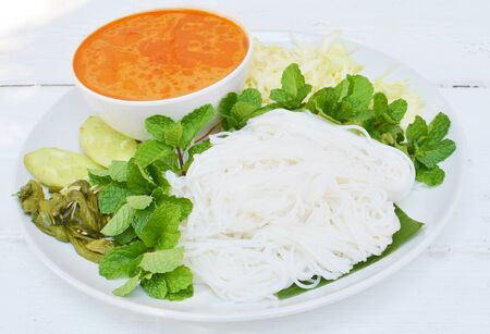 Rice noodles in fish curry sauce with vegetablesの写真素材