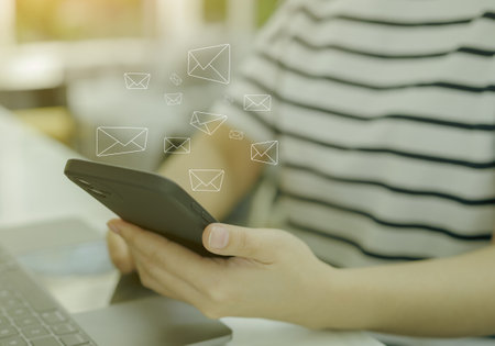 Woman using smart phone with email icon to send or read email work from home. Communication business technology concept. connection message to global letters. receive newsletter,の写真素材
