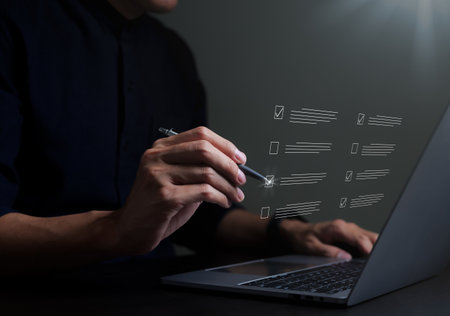 Businessman evaluating with checkboxes on online laptop computer. assessment survey online, choose correct answer in test, questions test, online exam, quiz knowledge, filling out an survey form.の写真素材