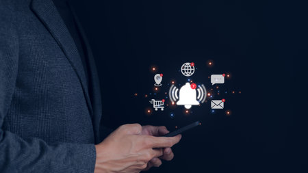Businessman using smartphone with virtual bell ringing for application notification alert concept....