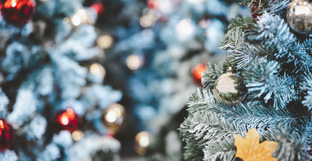 Close-up shot focus on gold bauble hanging from a decorated Christmas tree. Retro filter effect. Christmas tree and Christmas decorations. red bauble,の写真素材