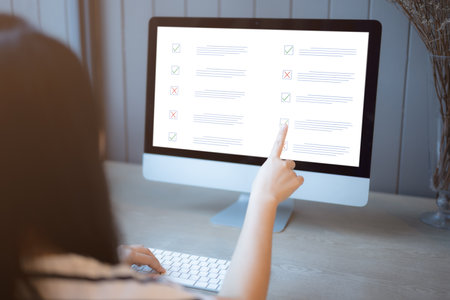 <p>Woman passing online exam, Questionnaire online with checkboxes, Evaluation, Online survey online exam Choosing the right answer in the exam, Test questions. Filling out online survey form business.</p>の写真素材