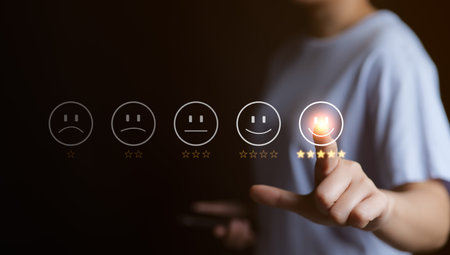 Customer service evaluation concept. User pressing smile face emoticon on virtual touch screen. quality review, feedback survey, best rating positive five star, marketing research, satisfaction client.の写真素材