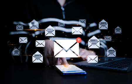 Woman checking email and sending email on smartphone. New email notification concept for business e-mail communication and digital marketing. Inbox, receiving electronic message alert.の写真素材