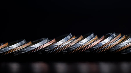 Close up of Coins are lined up in front on table. background is black. business and finance concept.